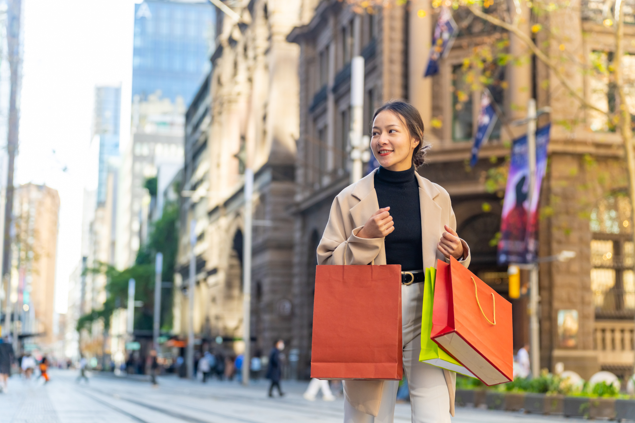Portrait of Happy Asian woman holding shopping bag walking and shopping in the city together. Attractive girl enjoy and fun urban outdoor lifestyle walking and travel city street on holiday vacation.